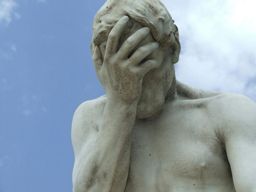 A dramatic close-up of a renowned statue in Paris expressing frustration.