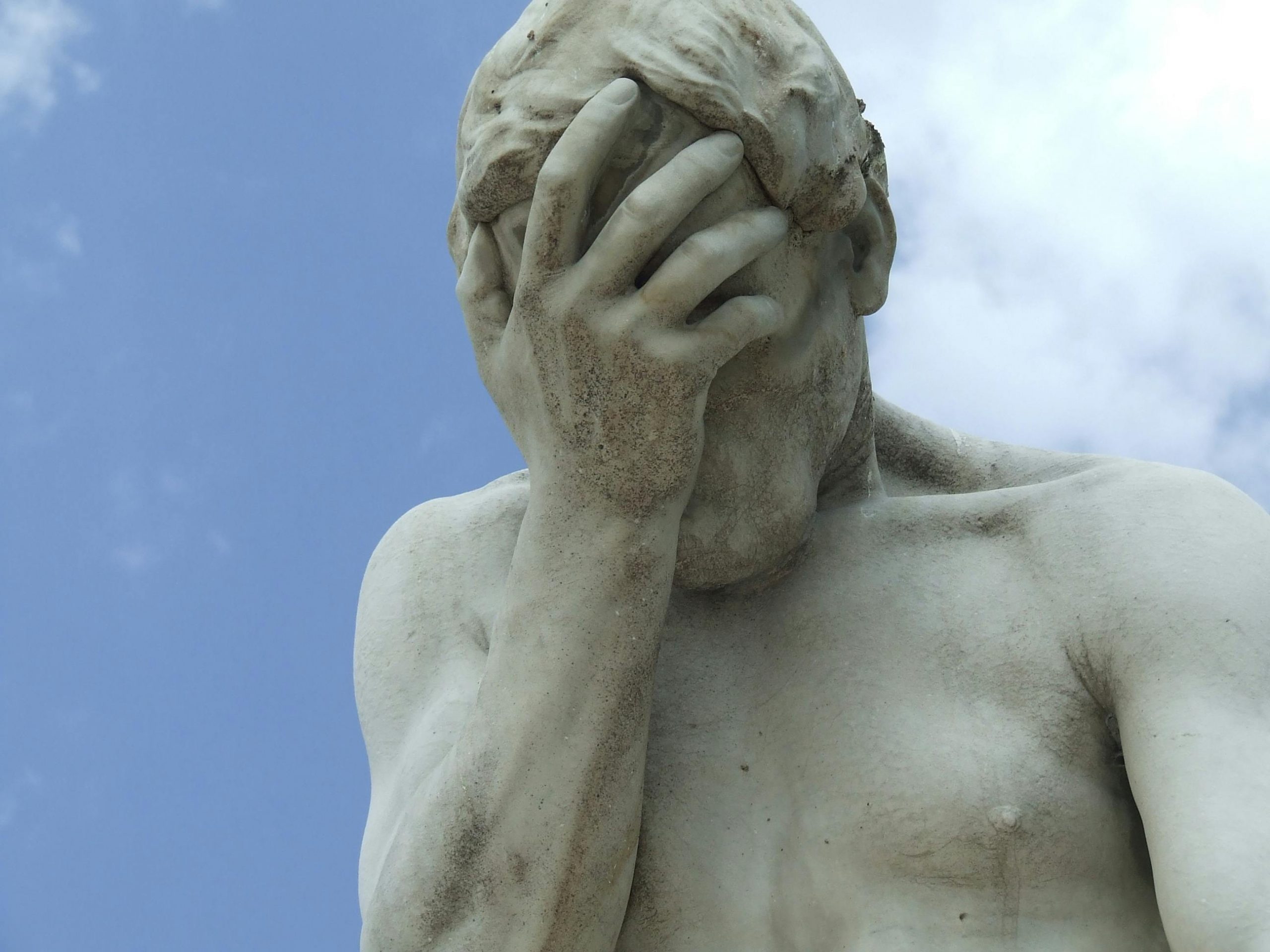 A dramatic close-up of a renowned statue in Paris expressing frustration.